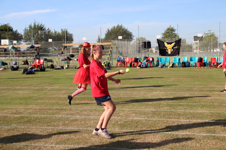 Students walking whilst balancing tennis balls on spoons